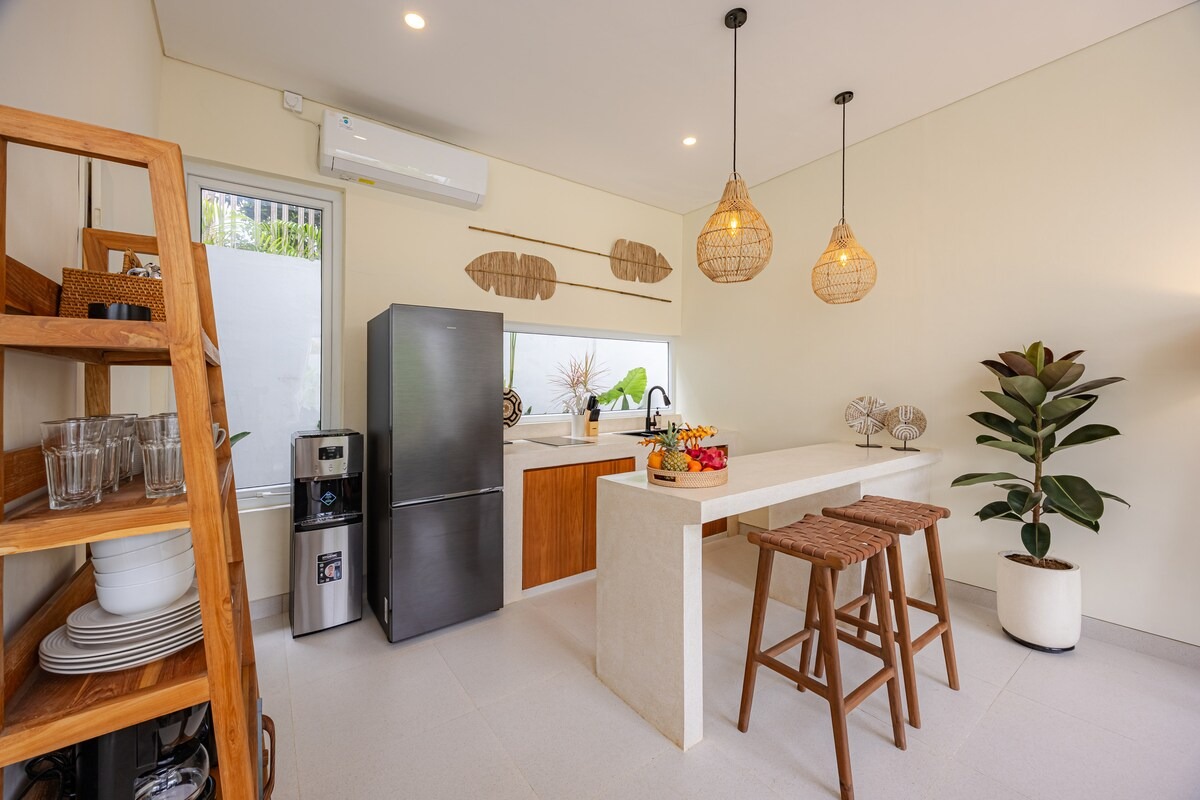 Kitchen with wooden cabinetry and rattan pendant lights