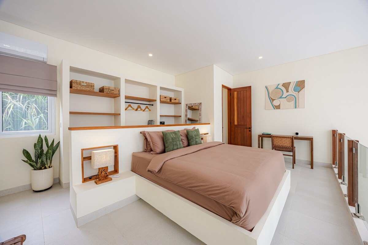 Mezzanine bedroom with king bed facing the open shelving