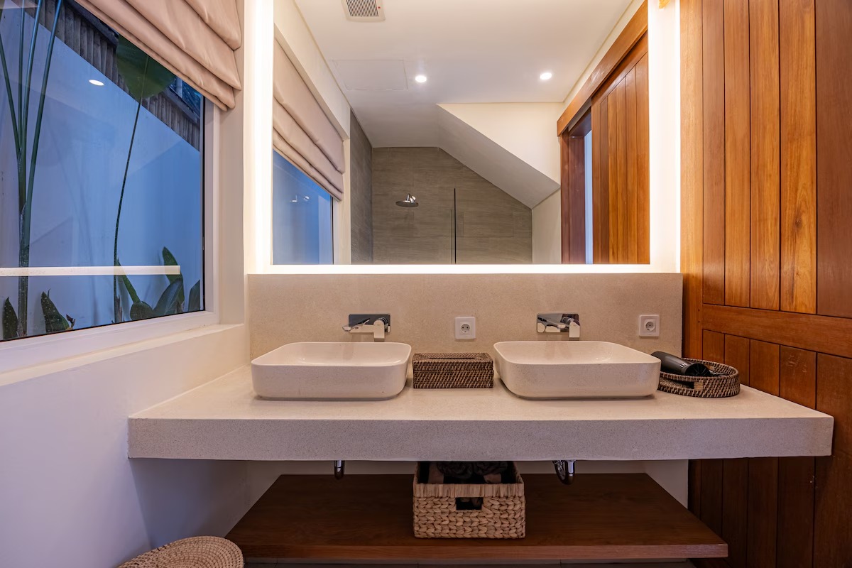Bathroom with double vanity and backlit mirror